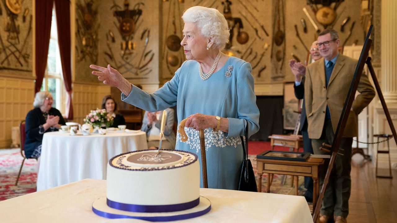 Britain's Queen Elizabeth cuts a cake to celebrate the start of the Platinum Jubilee during a reception in the Ballroom of Sandringham House, which is the Queen's Norfolk residence, in Sandringham, Britain. Credit: Reuters Photo