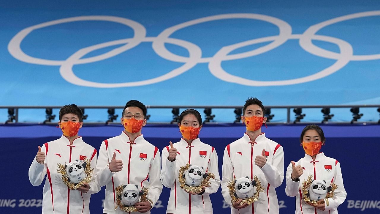 Team China celebrate on the podium after winning the gold medal in the mixed team relay. Credit: AFP Photo