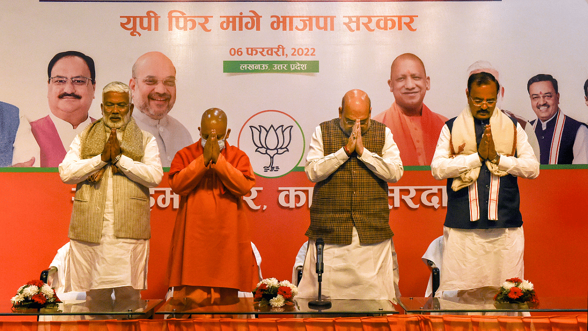 Union Minister Amit Shah, Uttar Pradesh Chief Minister Yogi Adityanath, State Unit President of BJP Swatantra Dev Singh and Deputy Chief Minister Keshav Prasad Maurya offering condolences on the death of Bharat Ratna Lata Mangeshkar at the party office in Lucknow. Credit: PTI Photo