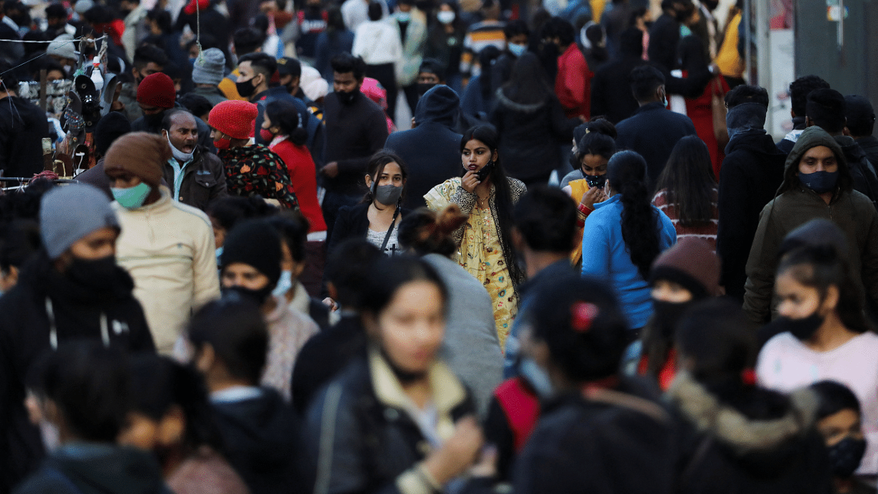 People shop at a market amidst the spread of coronavirus disease in New Delhi. Credit: Reuters Photo