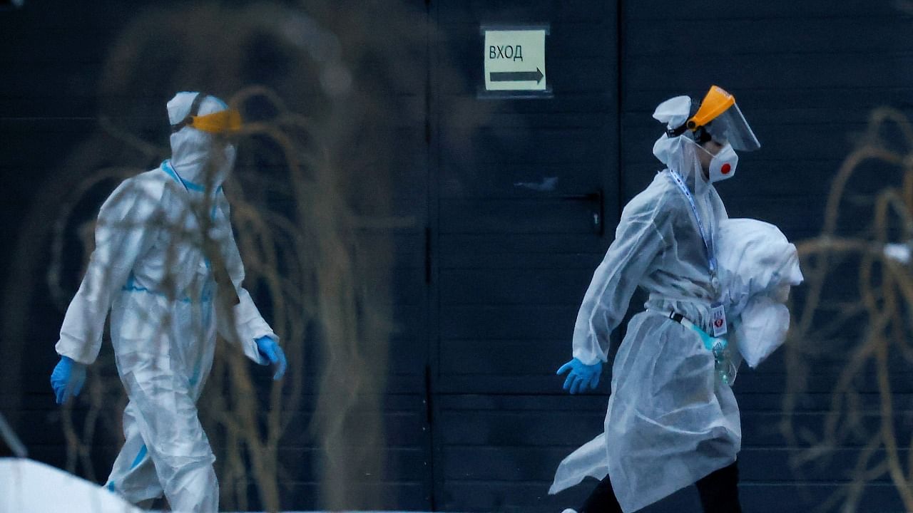 Medical specialists walk outside a hospital for patients infected with the coronavirus disease (COVID-19) on the outskirts of Moscow. Credit: Reuters Photo