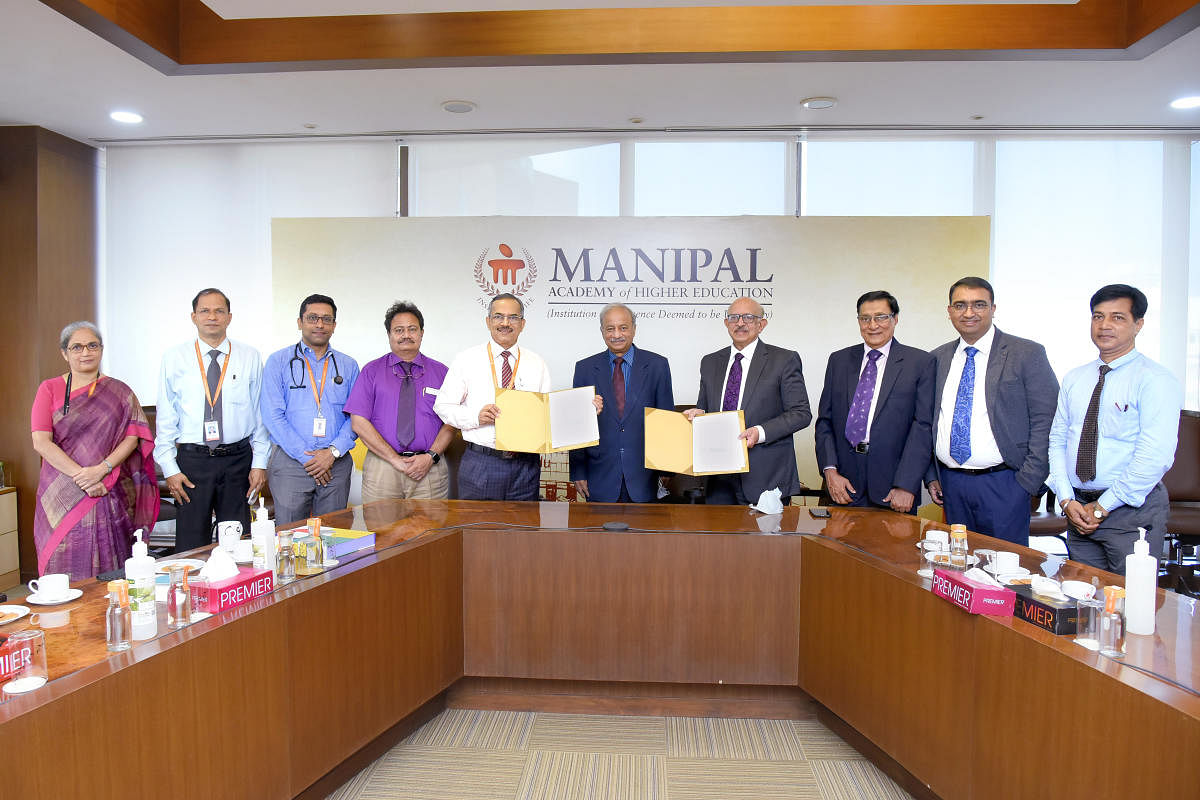 Dignitaries exchange copies of the MoU between MAHE and Velbiom Probiotics Private Limited in Manipal.