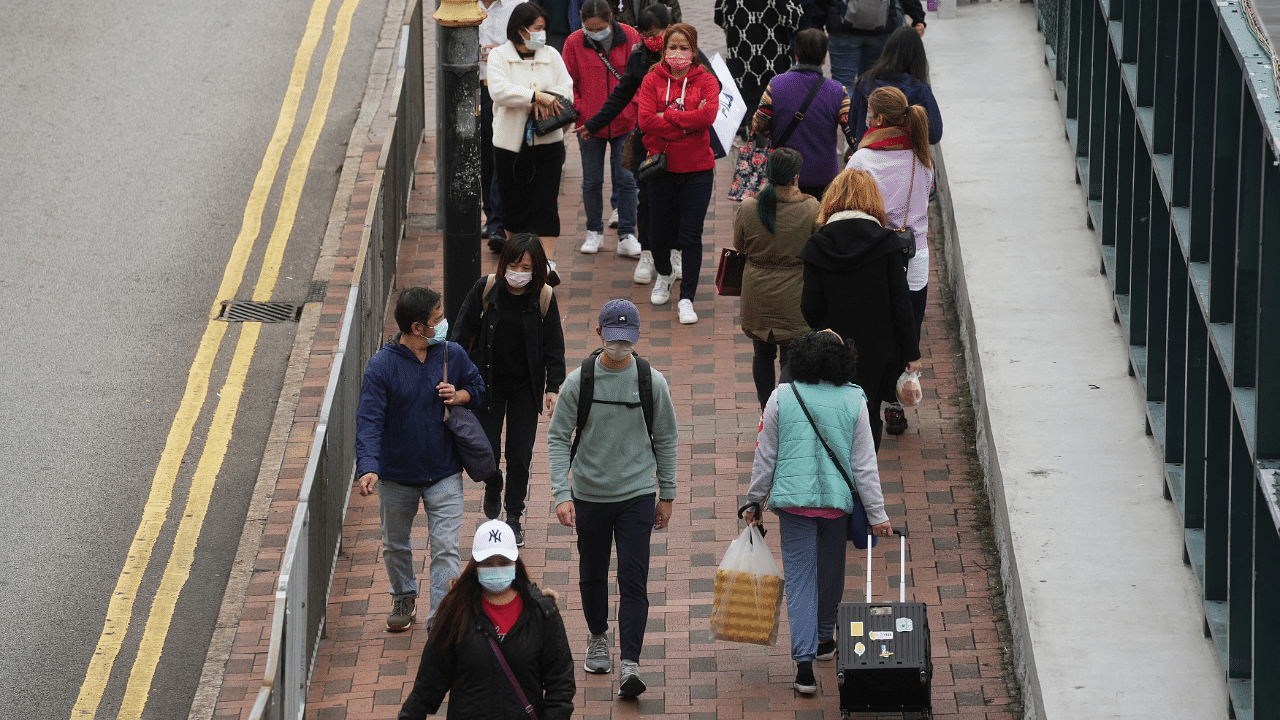Pedestrians wearing face masks following the coronavirus disease outbreak walk on a street in Hong Kong. Credit: Reuters Photo