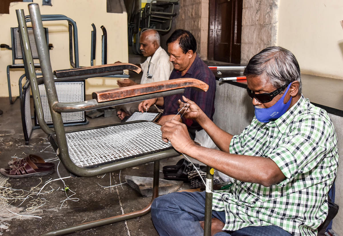 Maleyappa and other visually impaired workers braid plastic-wired chairs. DH PHOTO/Anup Ragh T