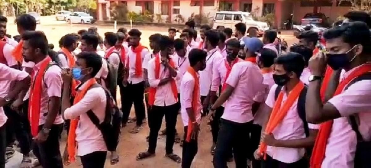 Students wearing saffron stoles stage a protest at Government First Grade Collegein Vamadapadavu in Bantwal.