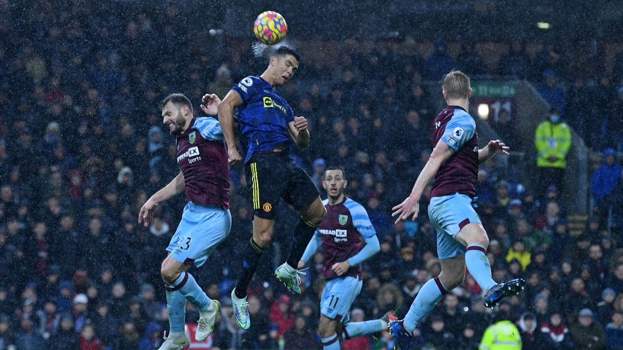 Manchester United's Cristiano Ronaldo (C) wins a header during the English Premier League football match against Burnley. Credit: AFP Photo