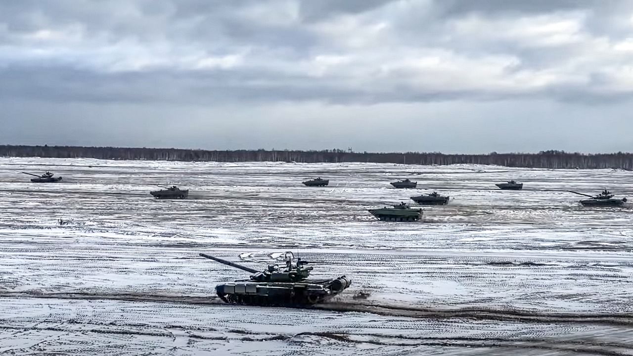 This handout video grab released by the Russian Defence Ministry on February 4, 2022 shows tanks on a snow-covered field during joint exercises of the armed forces of Russia and Belarus as part of an inspection of the Union State's Response Force, at a firing range in Belarus. Credit: AFP Photo