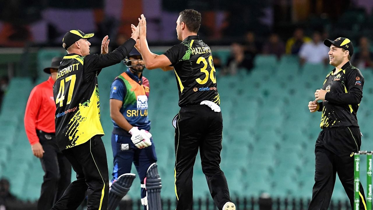 Australia's Josh Hazlewood (C) celebrates his wicket of Sri Lanka's batsman Chamika Karunaratne with teammates. Credit: AFP Photo