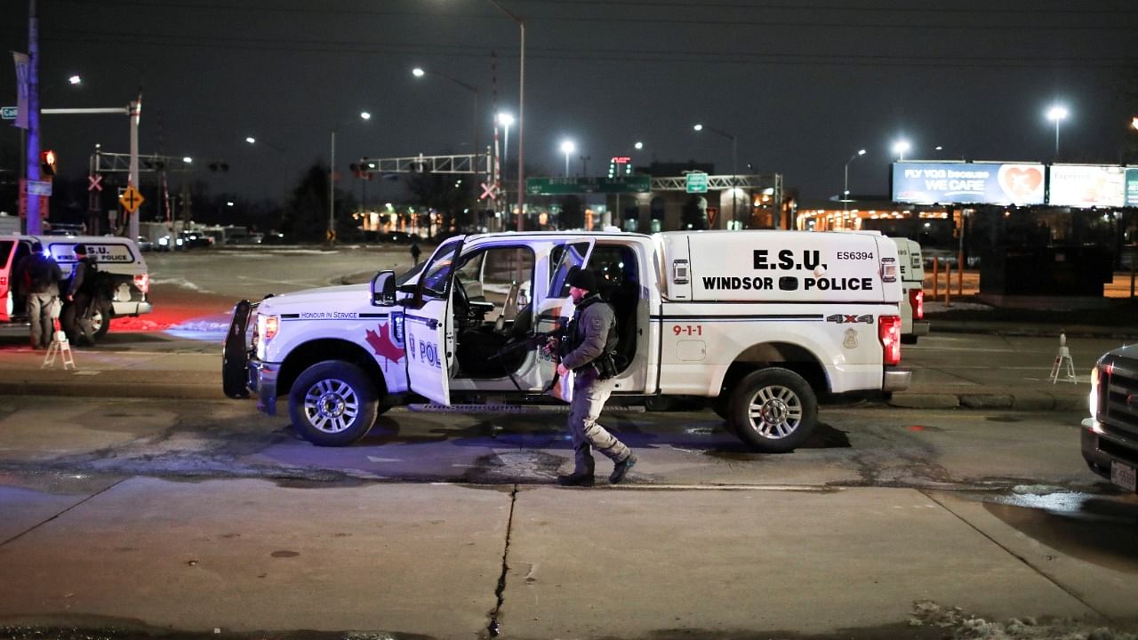 Police officers prepare to change shifts as truck drivers and supporters continue to block access to the Ambassador Bridge, which links Detroit and Windsor, in protest against coronavirus disease (Covid-19) vaccine mandates, in Windsor, Ontario, Canada February 10, 2022. Credit: Reuters Photo