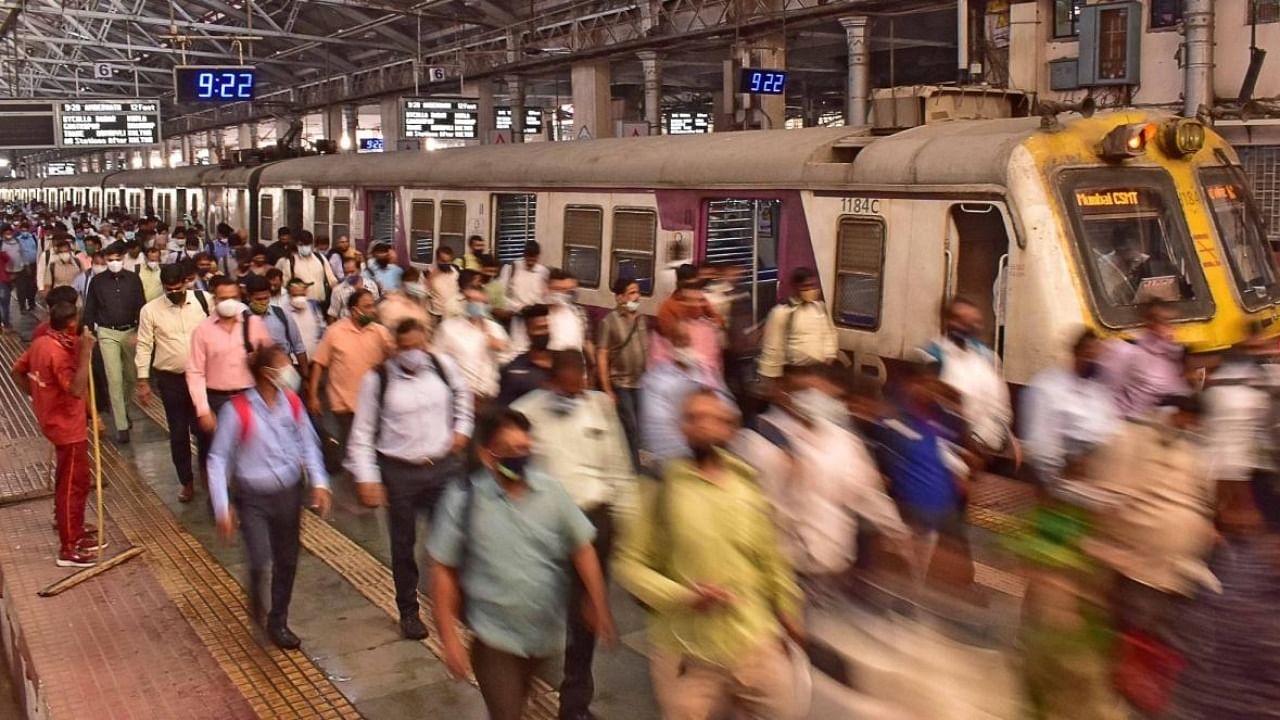 Mumbai:Passengers deboard from a local train at a railway station in Mumbai. Credit: IANS Photo