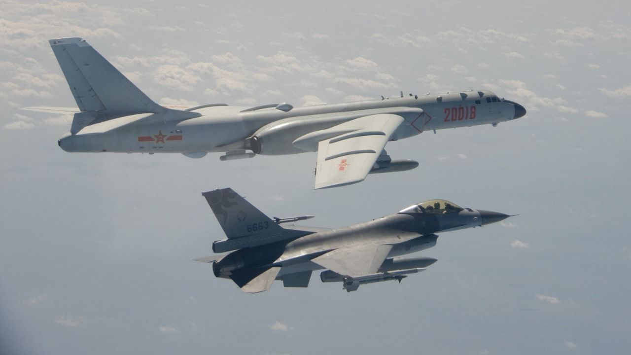 A Taiwanese F-16 fighter jet flies next to a Chinese H-6 bomber (top) off the coast of Taiwan. Credit: AFP File Photo