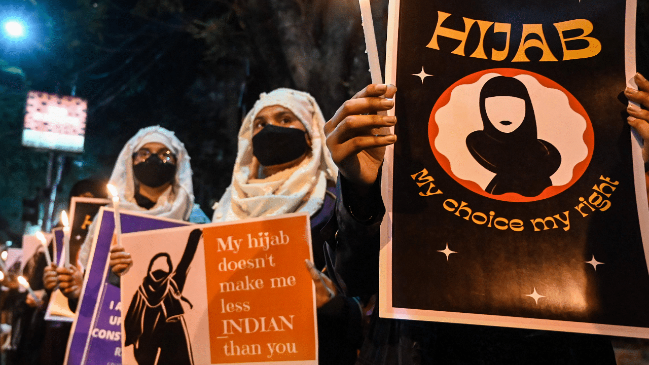 Muslim women hold placards as they take part in a demonstration. Credit: AFP Photo