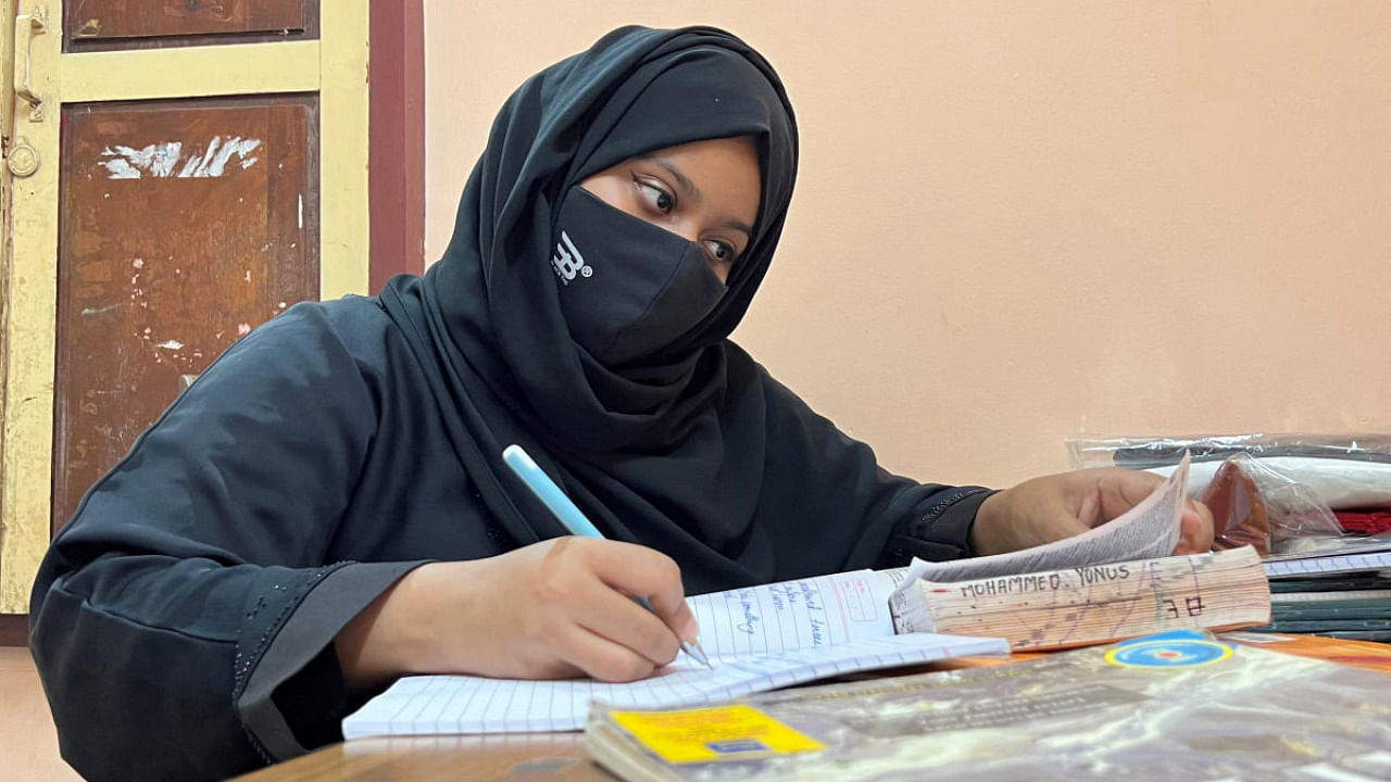 Ayesha Imthiaz, 21, a Muslim college student, wearing a hijab, studies in a room in Udupi. Credit: Reuters photo