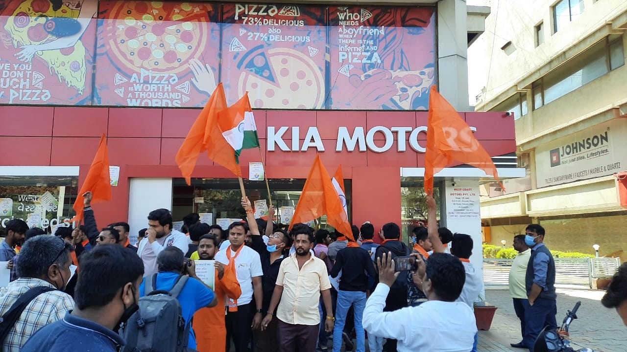 Bajrang Dal members shutting down KIA motors showroom and Pizza Hat in Ahmedabad. Credit: Special arrangement