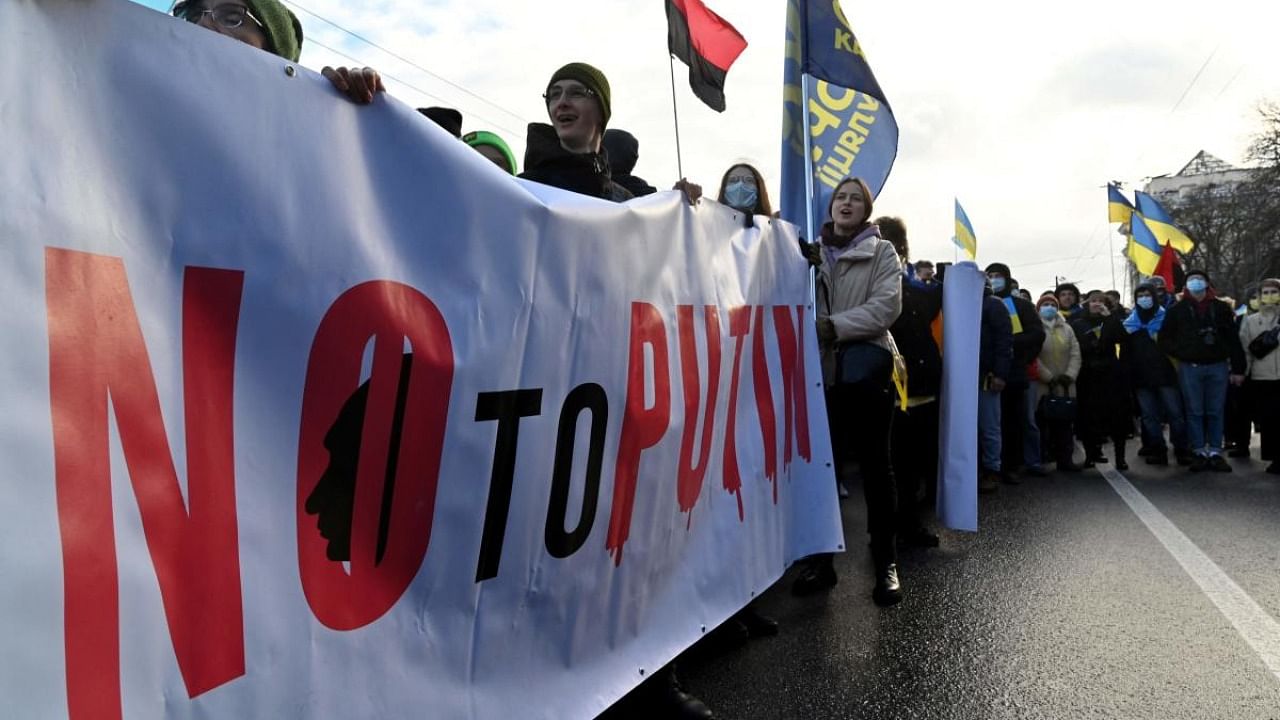 Demonstrators shout slogans as they march with a banner reading as 'No to Putin' during a rally in Kyiv. Credit: AFP Photo