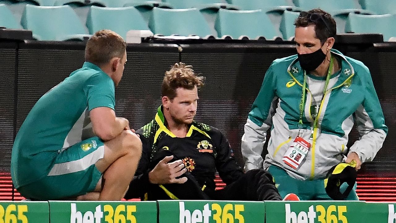 Australia's Steve Smith gets medical attention as he hits his head against the ground in an attempt to catch the ball during the 2nd T20 against Sri Lanka at the Sydney Cricket Ground. Credit: AFP File Photo