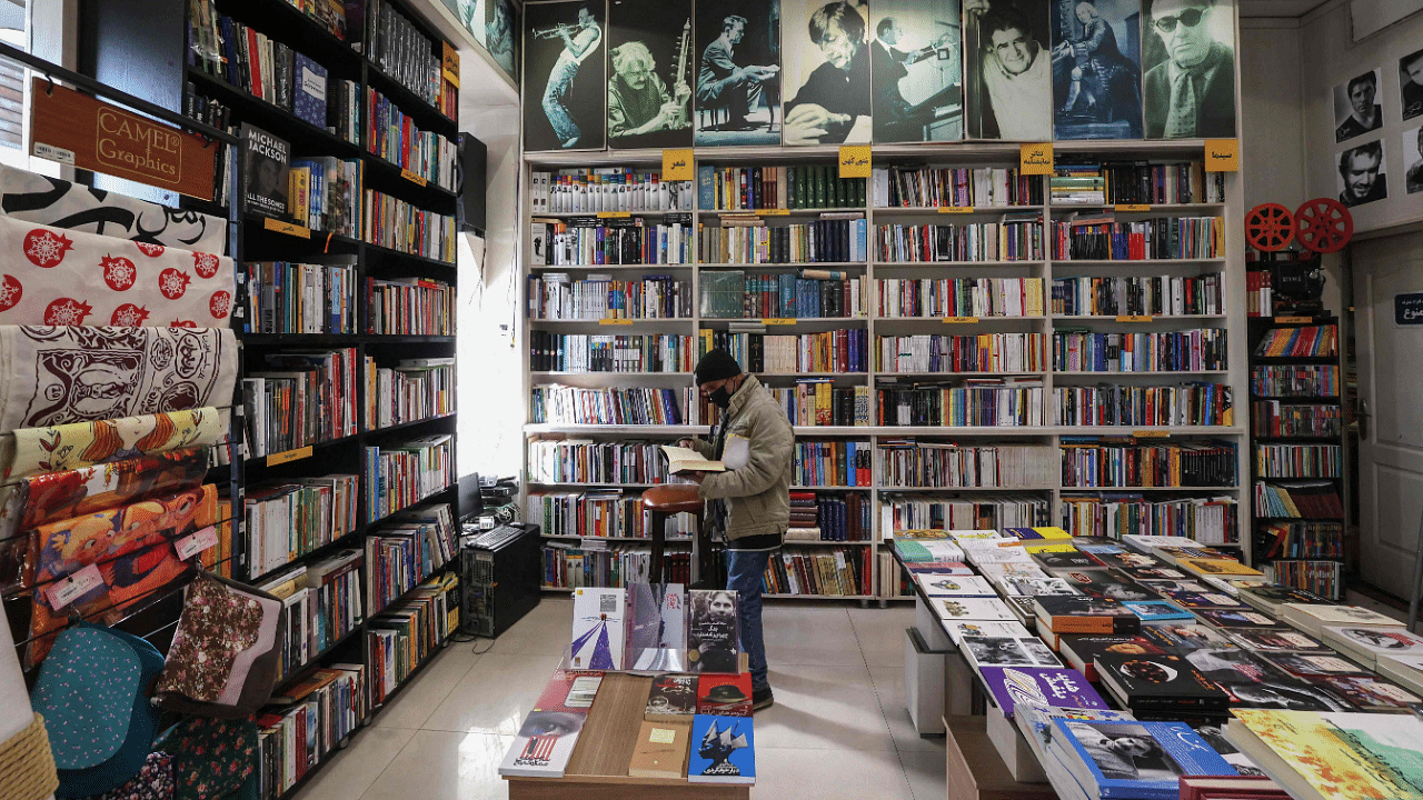 An Iranian man browses books at a library in Tehran. Credit: AFP Photo