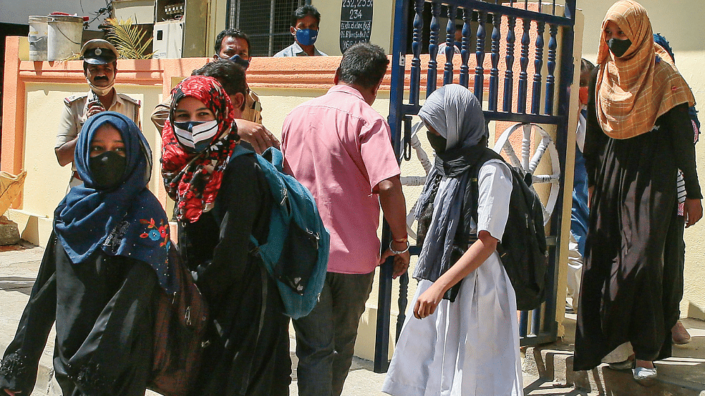 Students come out of their school after a teacher asked them to remove their 'hijab', in Bengaluru. Credit: PTI Photo