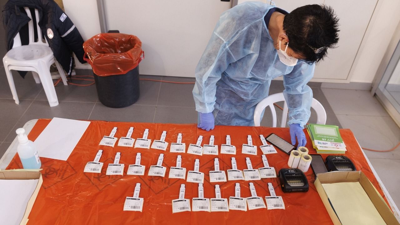 A medical worker waits for antigen test results at the Erez Crossing on the Israel-Gaza border in December. Credit: Bloomberg Photo