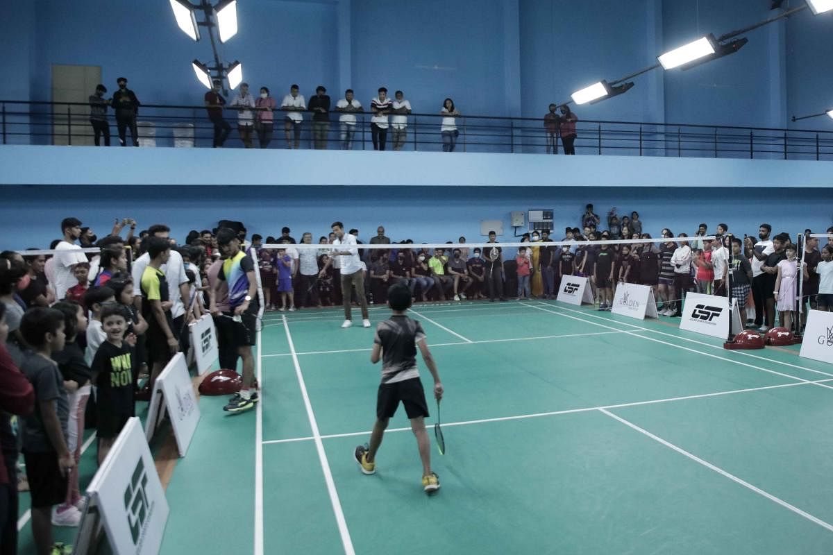A student of Golden Shuttle Excellence Centre plays a shot with Chirag Shetty, World No 8 badminton player in Mangaluru.