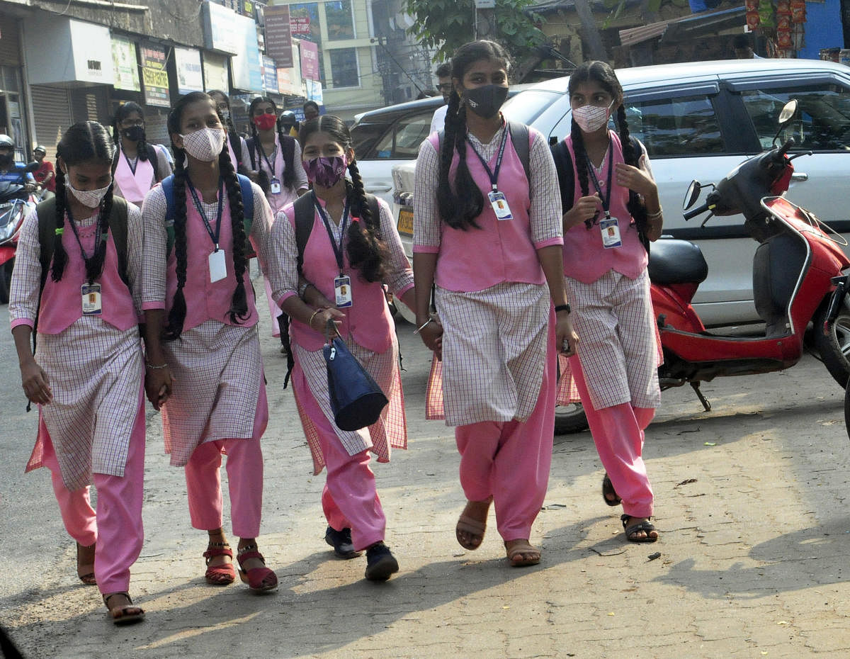 Students of the high school division of Government Girls PU College in Udupi arrive at school wearing uniforms.