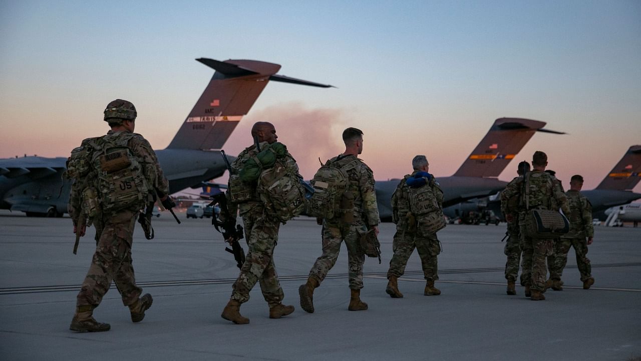 US soldiers walk to board a plane from Pope Army Airfield in Fort Bragg, North Carolina on February 14, 2021 as they are deployed to Europe. Credit: AFP Photo