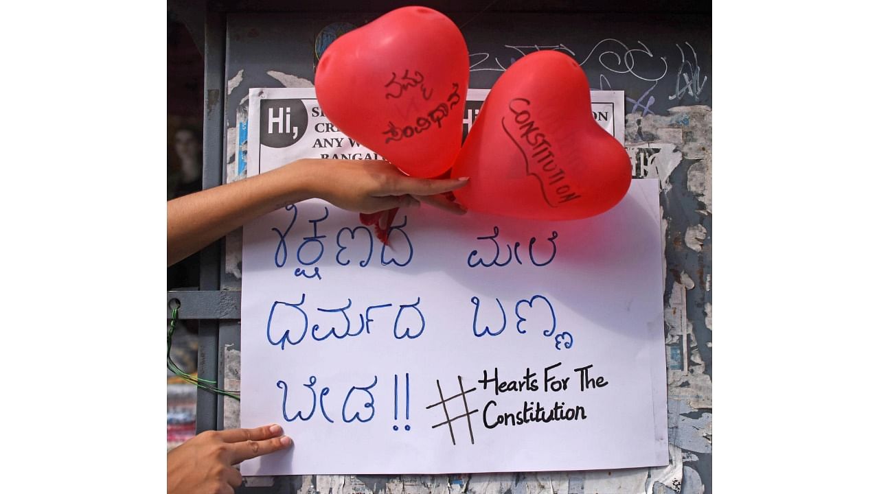 Balloons and posters with messages related to the Hijab row on Church Street. Credit: DH Photo/Pushkar V