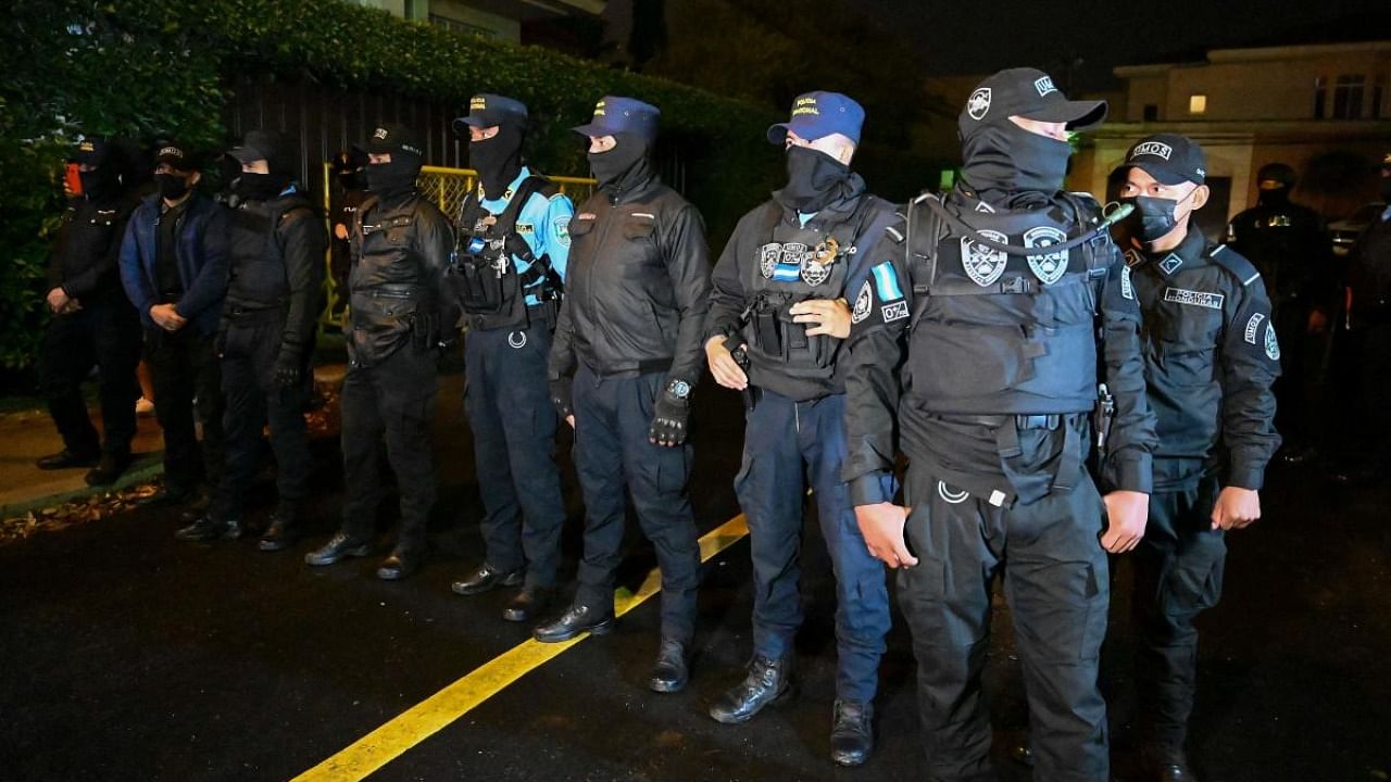 Members of the police special forces stand outside the home of former Honduran President Juan Orlando Hernandez in Tegucigalpa. Credit: AFP Photo