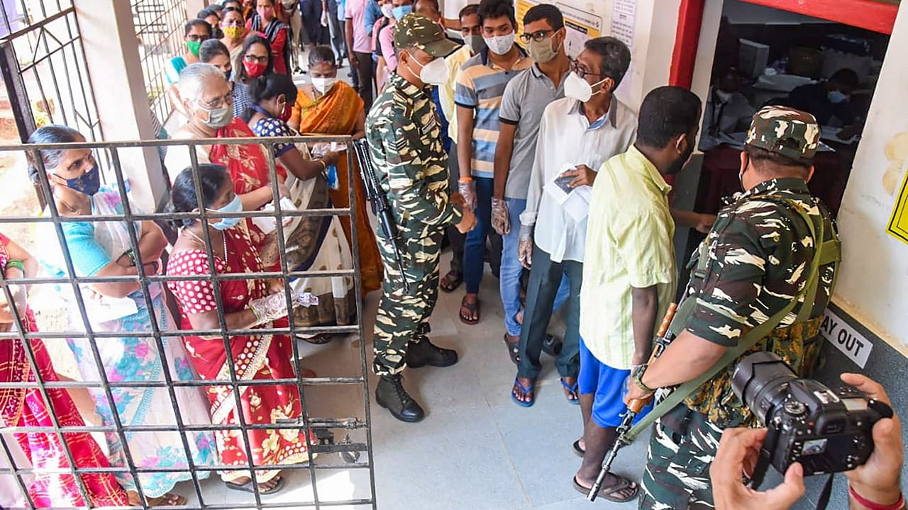 People stand in queues to cast their votes, during the Goa Assembly polls, at a polling station, in Goa, Monday, February 14, 2022. Credit: PTI Photo