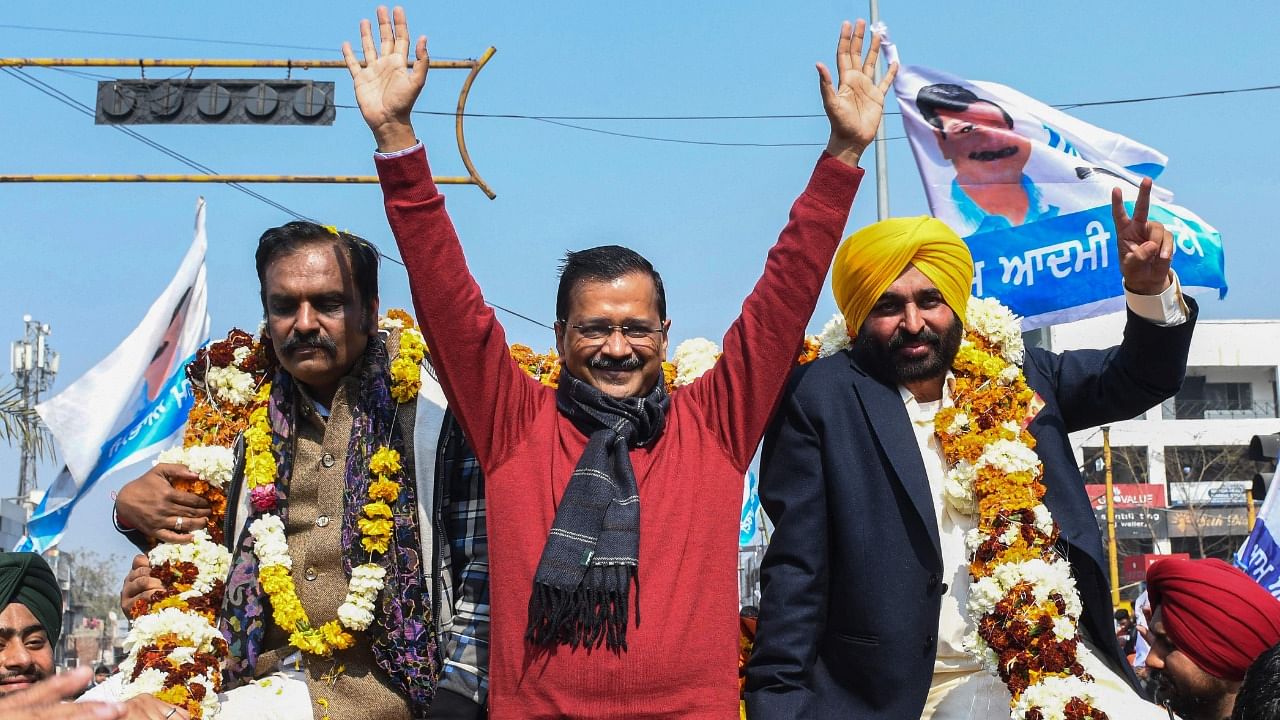 Arvind Kejriwal with AAP's CM candidate Bhagwant Mann (R). Credit: AFP Photo