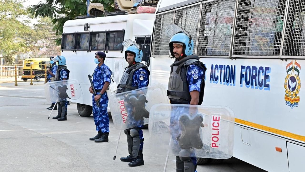 The personnel from Rapid Action Force deployed stand guard as the colleges reopened amid row over hijab, in Davangere on Wednesday. Credit: DH Photo/Satish Badiger