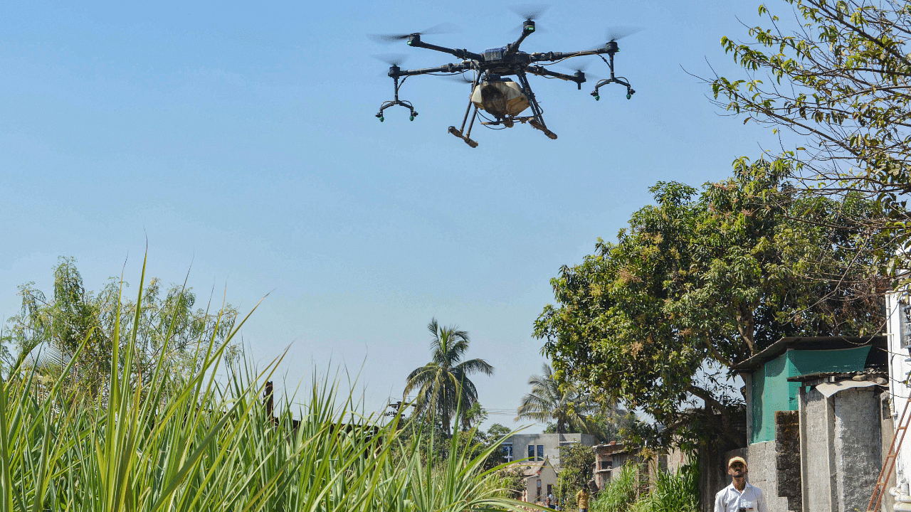Farmers spray pesticides using drone. Credit: PTI Photo