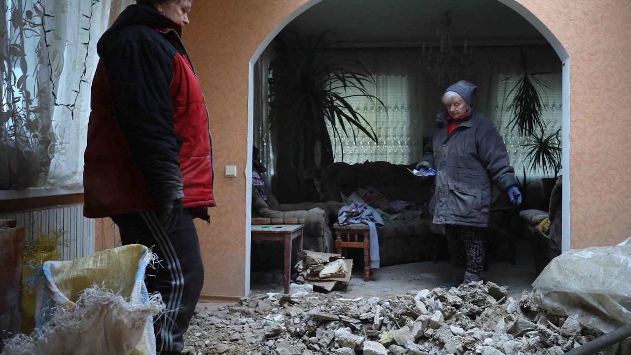  Local residents of the Ukrainian-controlled village of Stanytsia Luhanska, Luhansk region, clean up debris from homes after the shelling by Russia-Backed separatists. Credit: AFP Photo