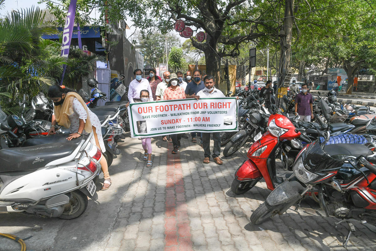 Double parking in front of hospitals and commercial establishments in Jayanagar, hinders pedestrian movement. DH Photos by S K Dinesh