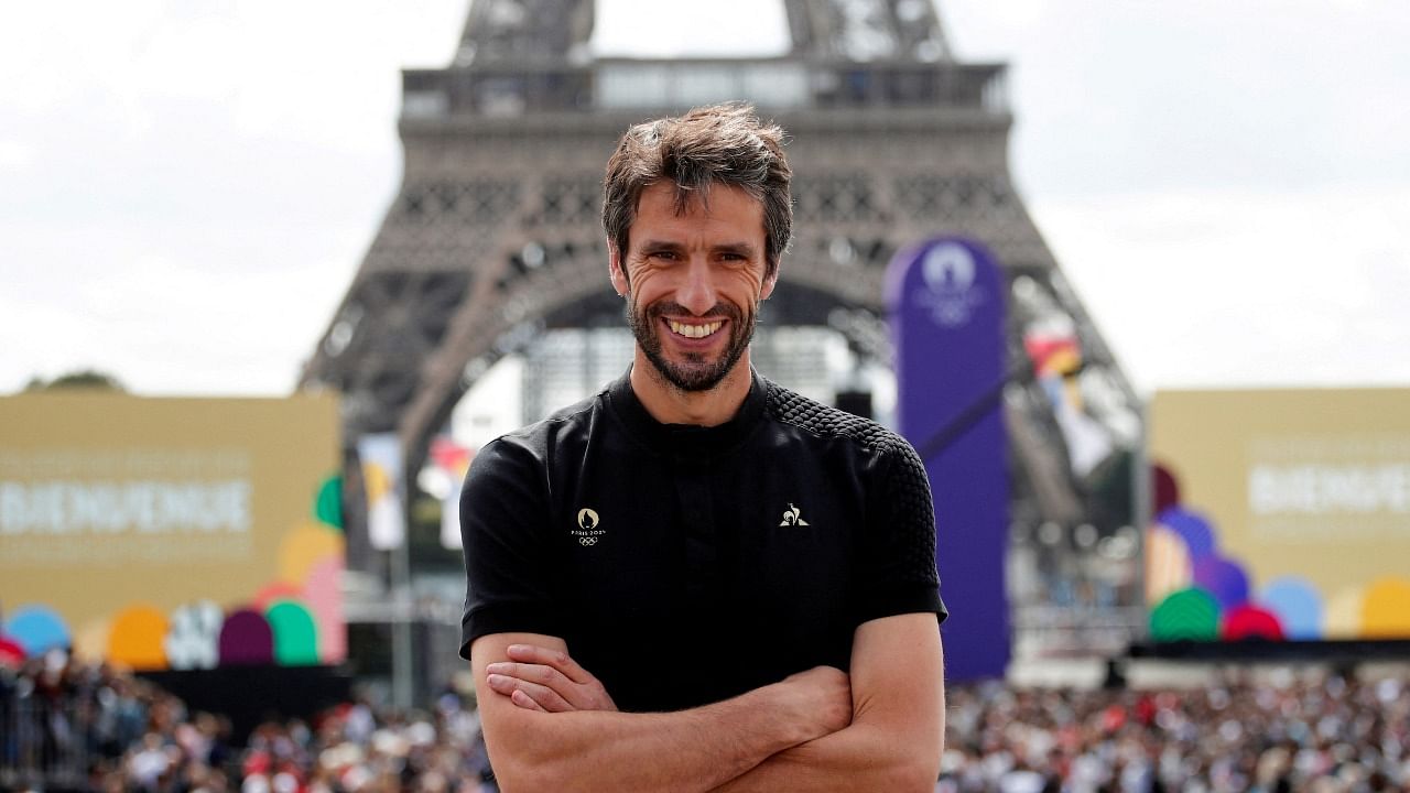 Paris 2024 Olympics Organising Committee President Tony Estanguet poses in front of the Eiffel Tower as people gather at Paris' Olympics fan zone. Credit: Reuters Photo