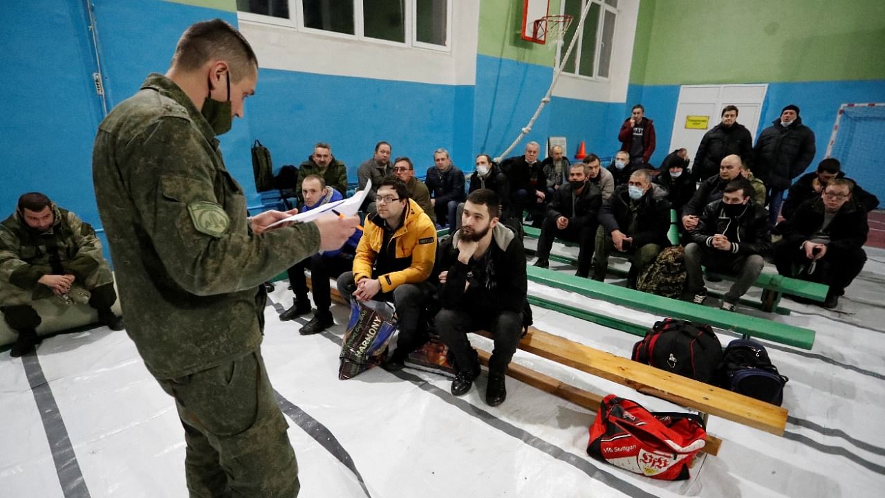 A militant of the self-proclaimed Donetsk People's Republic (DNR) reads out names of men registered at a military mobilization point in a school in the rebel-controlled city of Donetsk, Ukraine. Credit: Reuters Photo