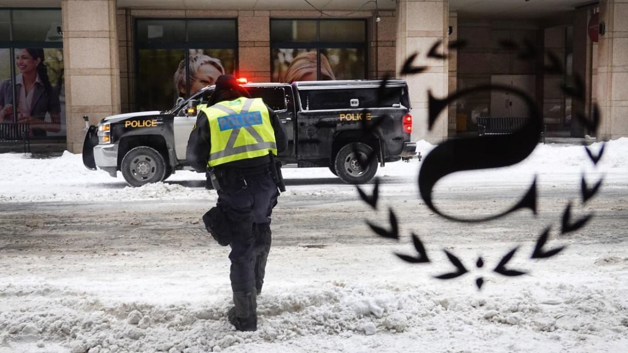 Police patrol the streets near Parliament Hill a day after they cleared a demonstration by truck drivers opposing vaccine mandates that had been entrenched for 23 days on February 20, 2022 in Ottawa. Credit: AFP Photo