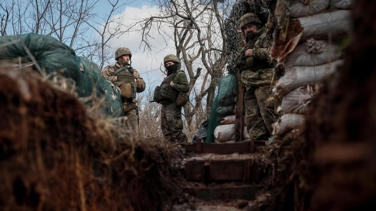 Ukrainian service members are seen on the front line near the city of Novoluhanske. Credit: Reuters Photo