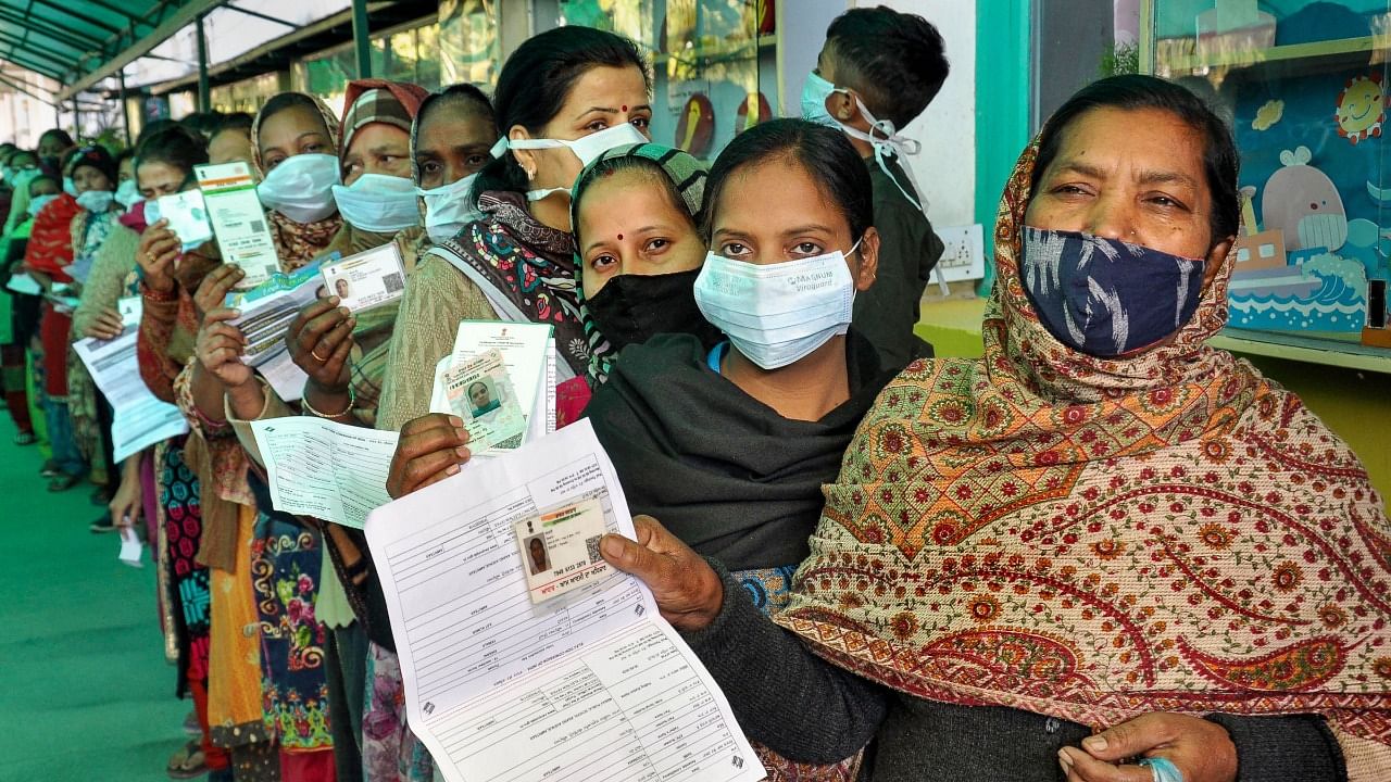 Women holding identification cards, stand in a queue to cast their votes, during the Punjab Assembly elections. Credit: PTI Photo