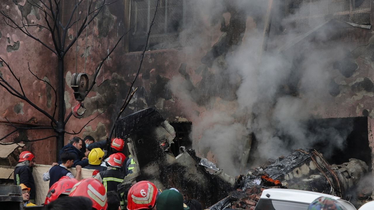 First responders work amid debris from the crashed fighter jet, in Tabriz, Iran, February 21, 2022. Credit: Mehr News/WANA (West Asia News Agency)/Reuters