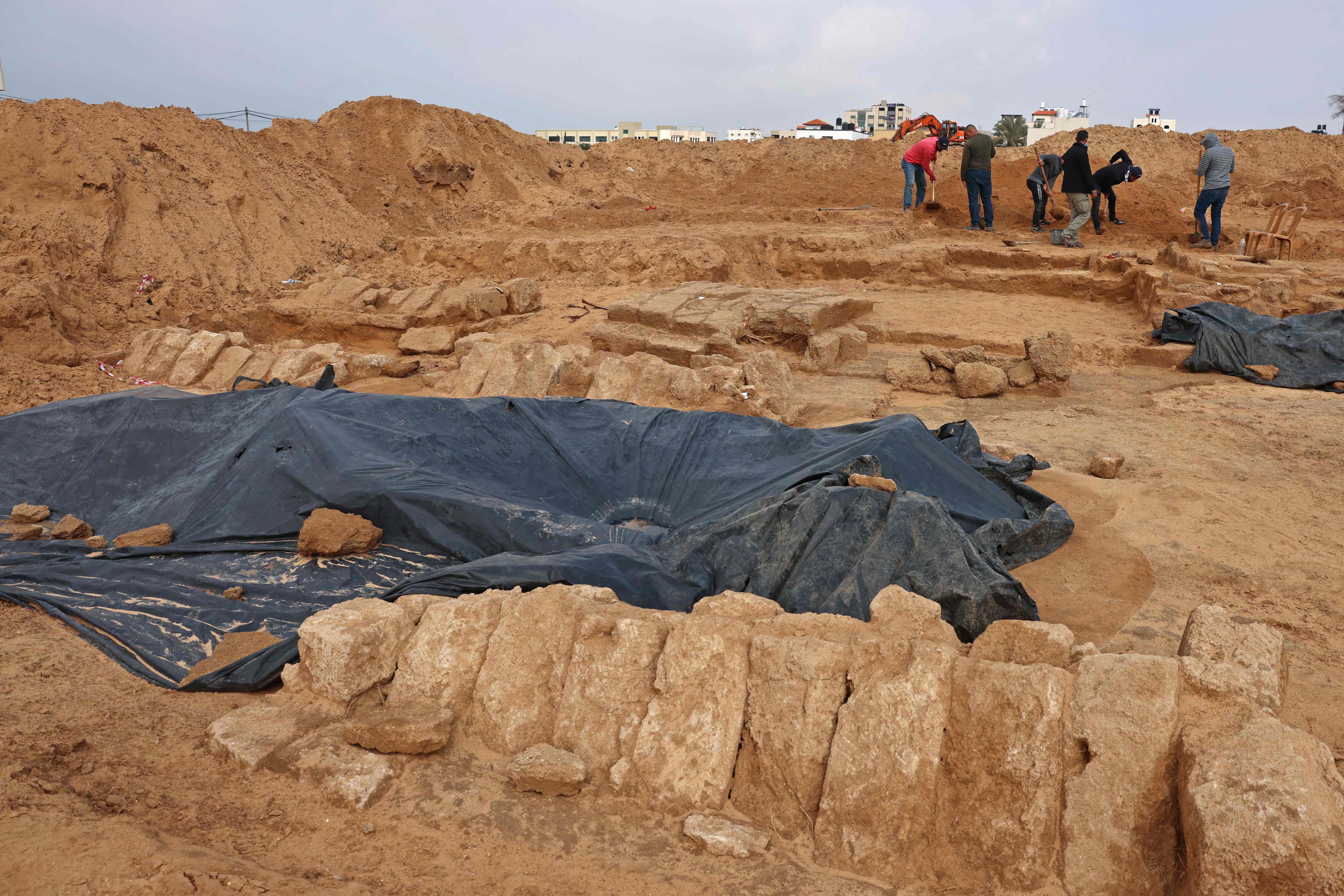 Palestinian workers excavate a newly discovered Roman cemetery containing ornately decorated graves, in Beit Lahia in the northern Gaza Strip. Credit: AFP Photo