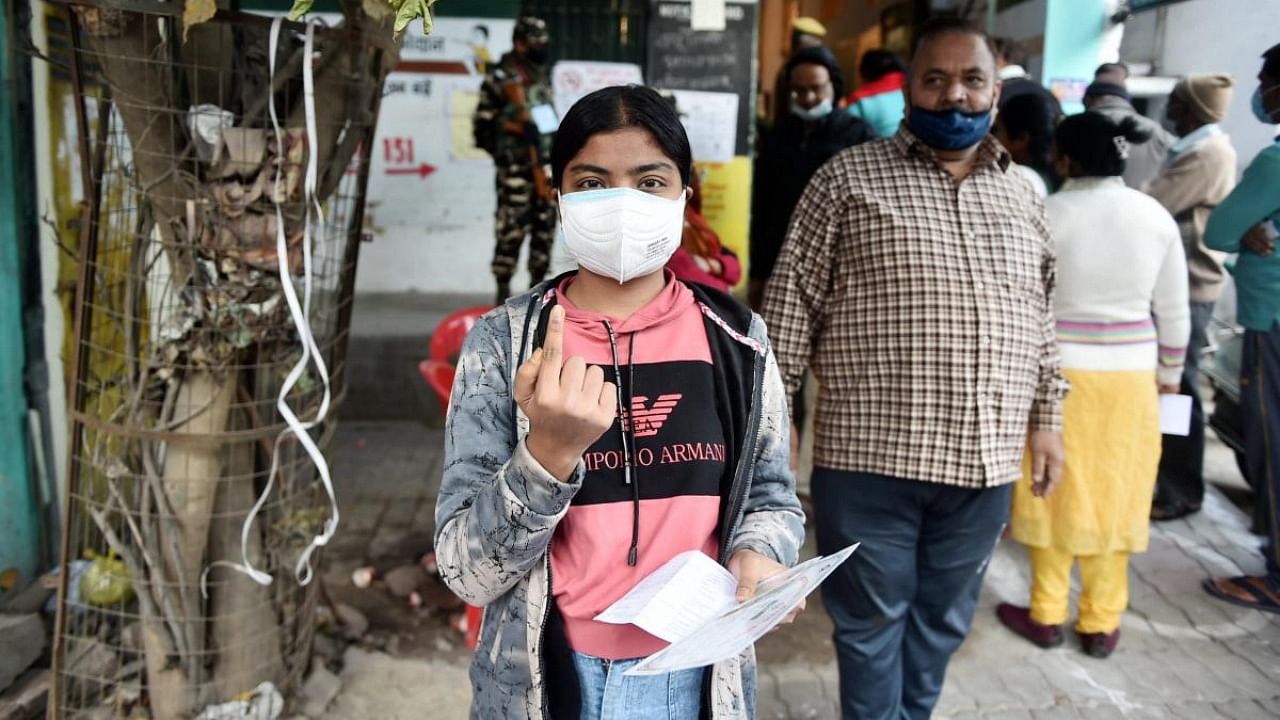 A first time voter shows her inked finger as she leaves after casting her vote at a polling station, during the third phase of UP Assembly polls, in Kanpur. Credit: PTI photo