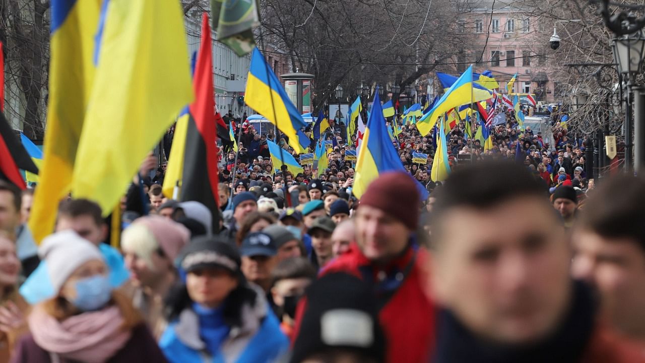 Protesters carry Ukrainian flags during a rally to show unity and support of Ukrainian integrity, amid soaring tensions with Russia, in the southern Ukrainian city of Odessa. Credit: AFP Photo