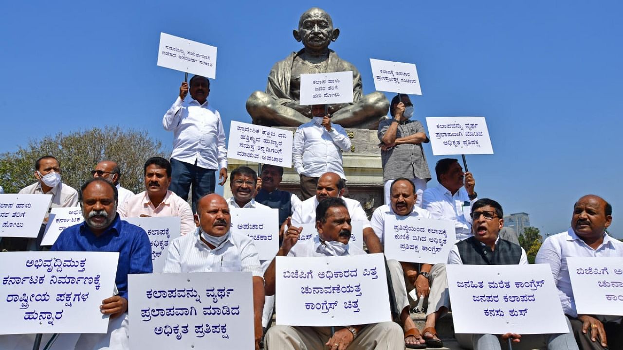 JD (S) members stage a protest blaming Congress and BJP for disruption of proceedings in both the houses of legislature, in Bengaluru on Monday. Credit: DH Photo/Krishnakumar P S
