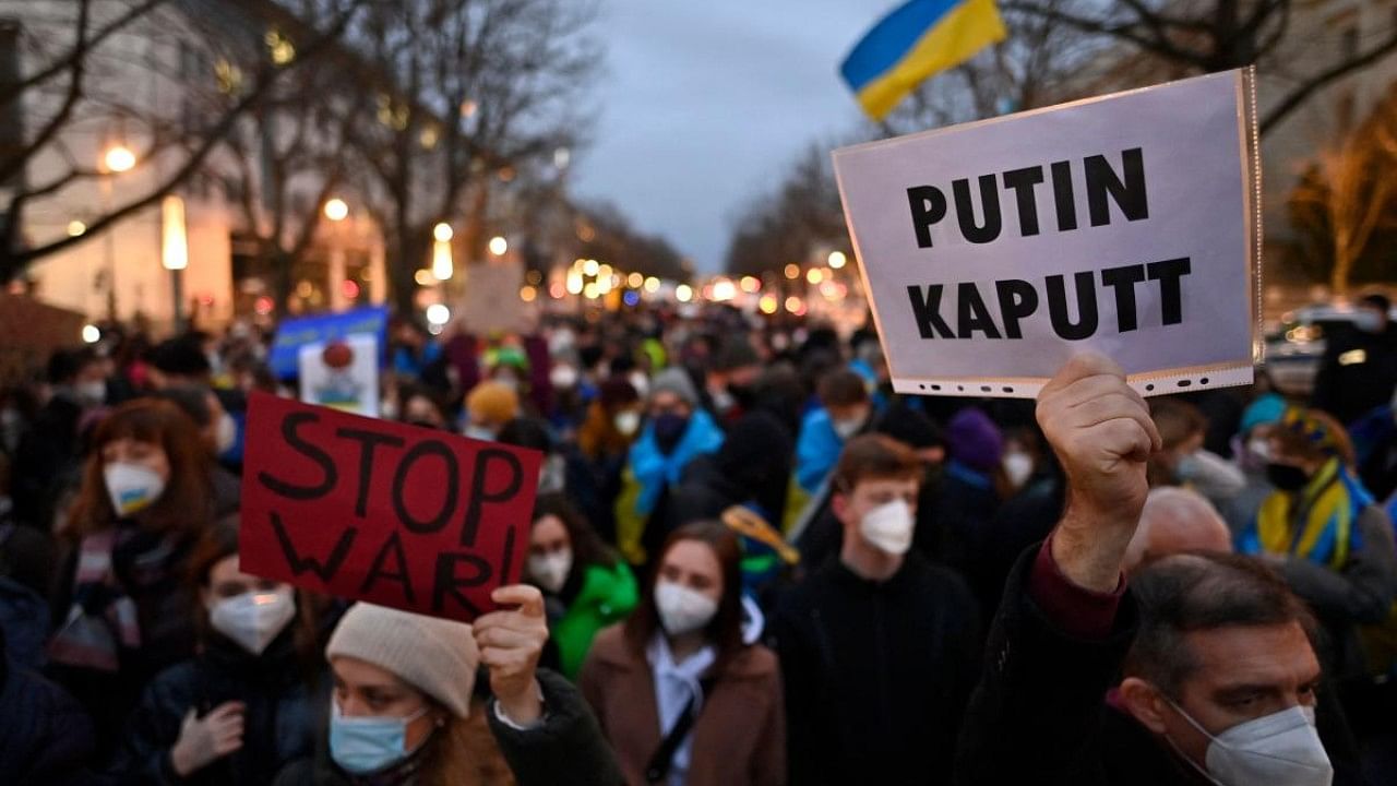 Pro-Ukraine demonstrators hold flags and placards during a demonstration. Credit: AFP Photo