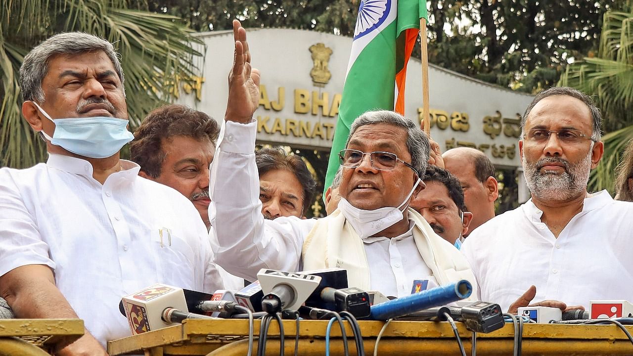 Former Karnataka CM S Siddaramaiah along with other Congress leaders addresses the media after meeting Karnataka Governor Thawarchand Gehlot seeking immediate action against minister K.S. Eshwarappa for his controversial statement regarding Indian flag. Credit: PTI Photo