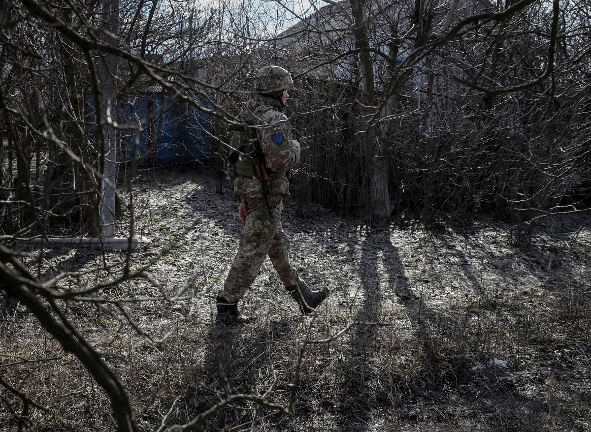 A Ukrainian serviceman walks along a street near the front line in the village of Travneve in Donetsk region, Ukraine February 21, 2022. Credit: Reuters Photo
