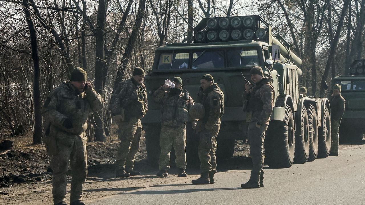 Ukrainian army soldiers stand next to multiple launch missile systems, after Russian President Vladimir Putin authorised a military operation, in eastern Ukraine. Credit: Reuters Photo