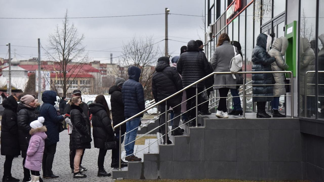 People queue at an ATM after Russian President Vladimir Putin authorised a military operation in eastern Ukraine, in Lviv. Credit: Reuters Photo