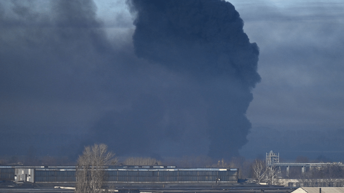 Black smoke rises from a military airport in Chuguyev near Kharkiv on February 24, 2022. Credit: AFP Photo